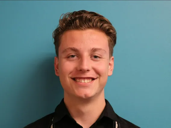 Headshot of a person with short brown/blonde hair.
