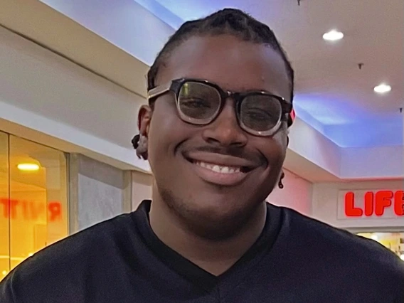 Person with glasses smiling
