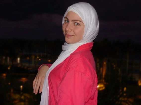 Person wearing hijab and pink shirt