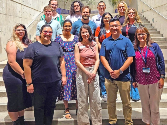 group of staff members standing in an outdoor stairwell