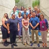 group of staff members standing in an outdoor stairwell